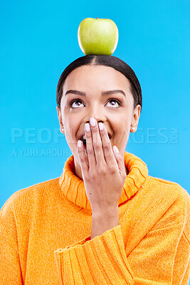 Buy stock photo Apple head balance, woman face and surprised with fruit product for weight loss benefits, healthy lifestyle or body detox. Organic food diet, nutritionist studio and shocked person on blue background