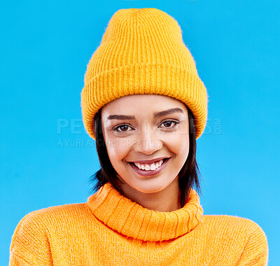 Buy stock photo Portrait of happy woman in winter fashion with beanie, jersey and isolated on blue background. Style, happiness and gen z girl in studio backdrop with smile on face and warm clothing for cold weather