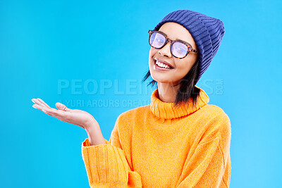 Buy stock photo Woman palm, smile and portrait in a studio with promotion and announcement. Excited, isolated and blue background with mockup of a gen z girl and cool young female show marketing with happiness