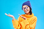 Woman palm, happiness and girl happy in a studio with promotion and announcement. Excited, isolated and blue background with mockup of a gen z and cool young female show marketing with smile