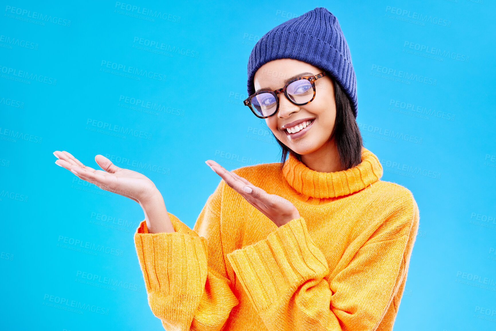 Buy stock photo Woman palm, happiness and girl happy in a studio with promotion and announcement. Model, isolated and blue background with mockup of a gen z and cool young female hands show marketing with smile