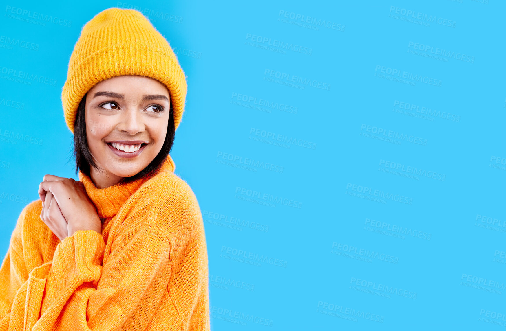 Buy stock photo Happiness, thinking and woman with fashion and mockup in studio in cold weather with winter hat. Isolated, blue background and mock up with a happy young and gen z person with a smile, beanie and joy