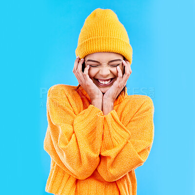 Buy stock photo Happiness, excited and woman with youth in studio ready for cold weather with winter hat. Isolated, blue background and smiling with a happy young and gen z person with a smile, beanie and joy