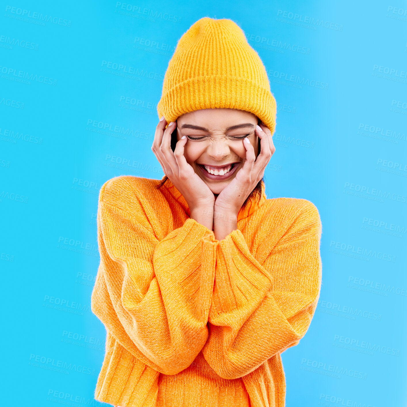 Buy stock photo Happiness, excited and woman with youth in studio ready for cold weather with winter hat. Isolated, blue background and smiling with a happy young and gen z person with a smile, beanie and joy