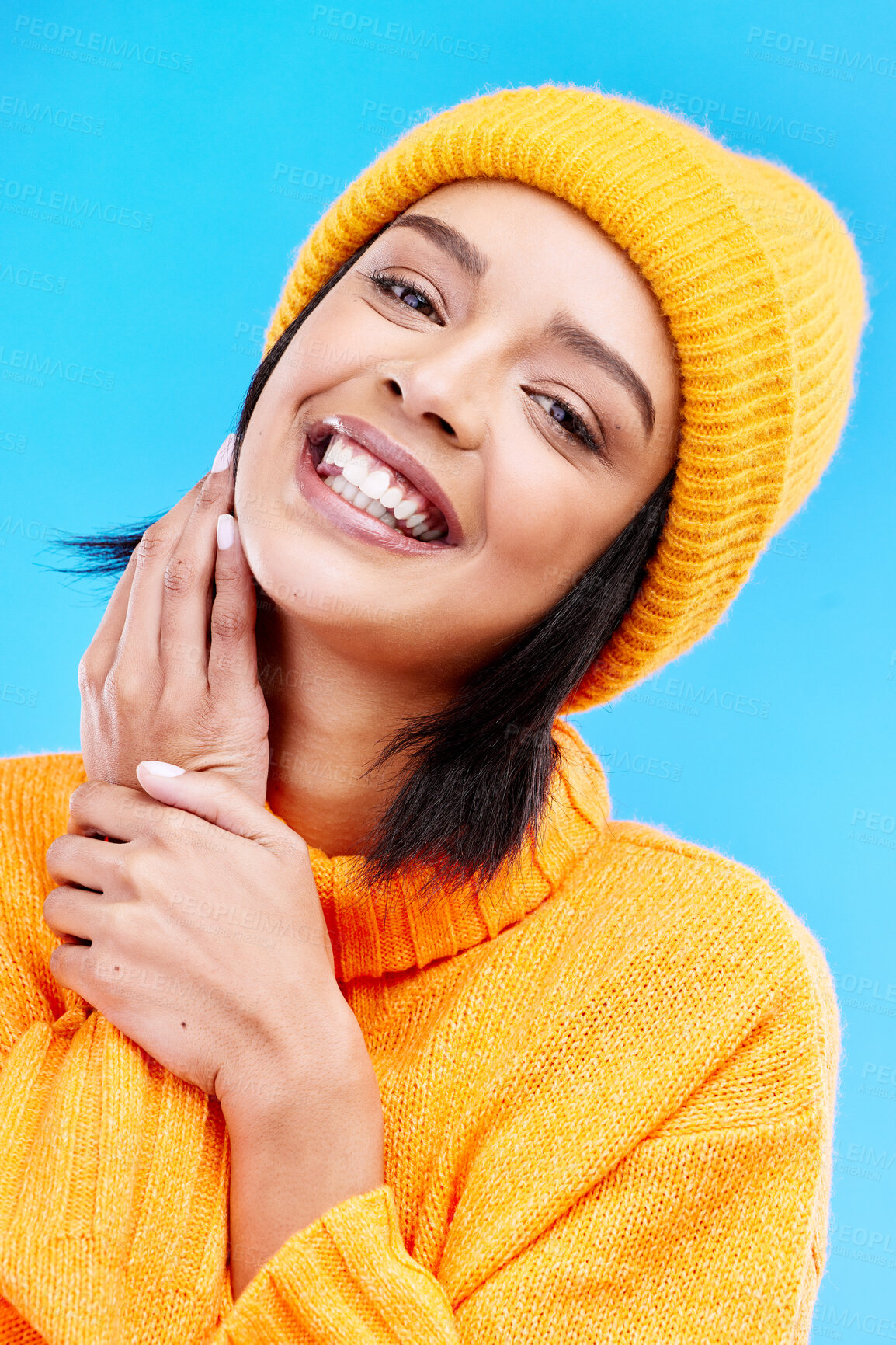 Buy stock photo Happiness portrait, excited and woman with youth in studio ready for cold weather with winter hat. Isolated, blue background and positivity with a young and gen z person with a smile, beanie and joy