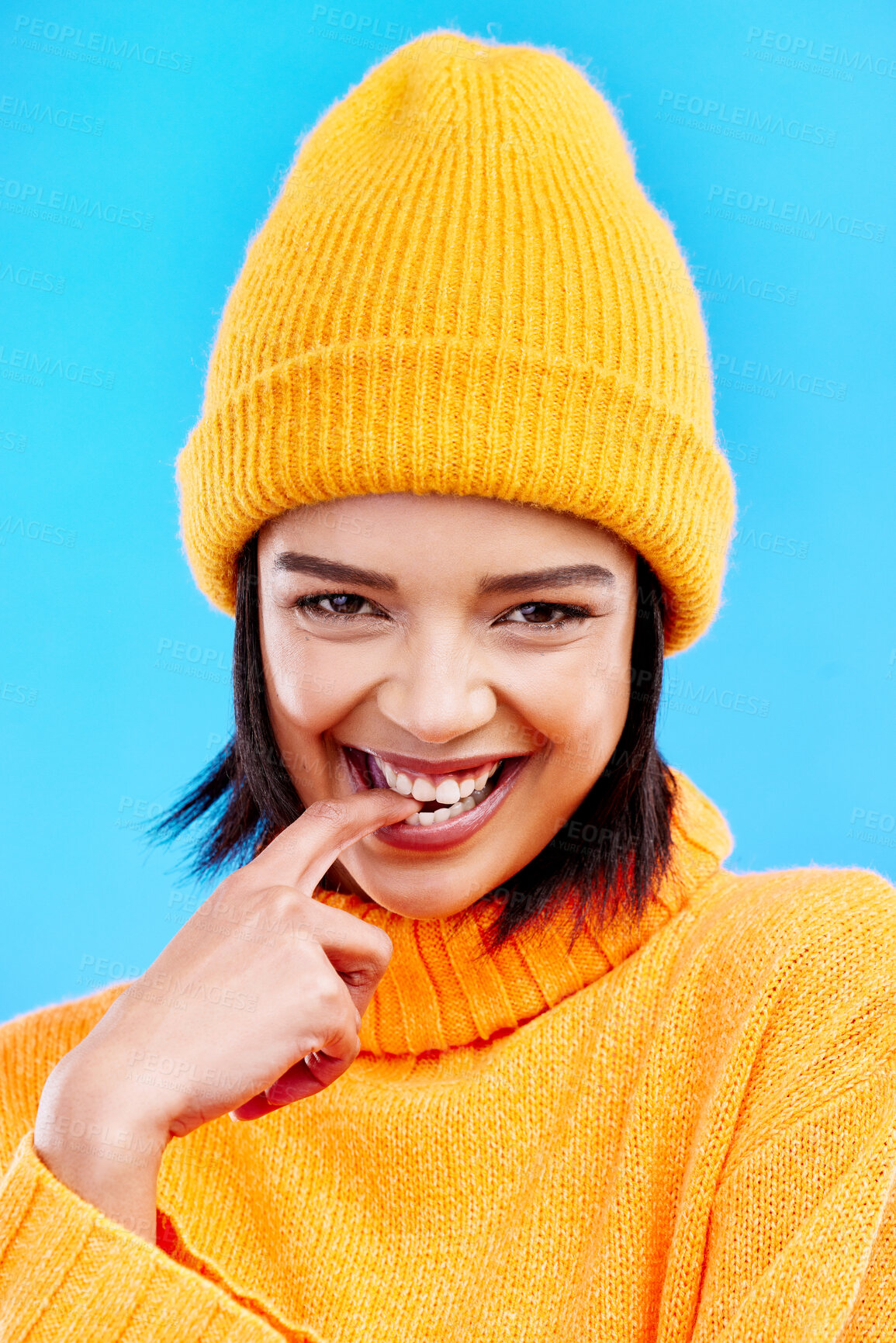 Buy stock photo Portrait of woman in winter fashion with happy face, beanie and smile isolated on blue background. Style, happiness and gen z girl in studio backdrop, mockup and flirt, warm clothing for cold weather