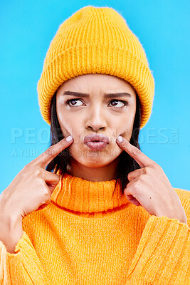 Buy stock photo Quirky, goofy and young female in a studio with a comic, funny and crazy face expression. Gen z, silly and beautiful woman model from Puerto Rico touching her cheeks isolated by a blue background.