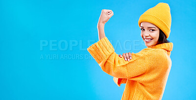 Buy stock photo Strong, mockup and a portrait of a woman with muscle isolated on a blue background in a studio. Smile, style and a girl showing fashion for empowerment and confidence on a backdrop with space