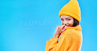 Buy stock photo Happiness, excited and woman portrait with mockup in studio ready for cold weather with winter hat. Isolated, blue background and mock up with a happy young and gen z person with a smile and joy