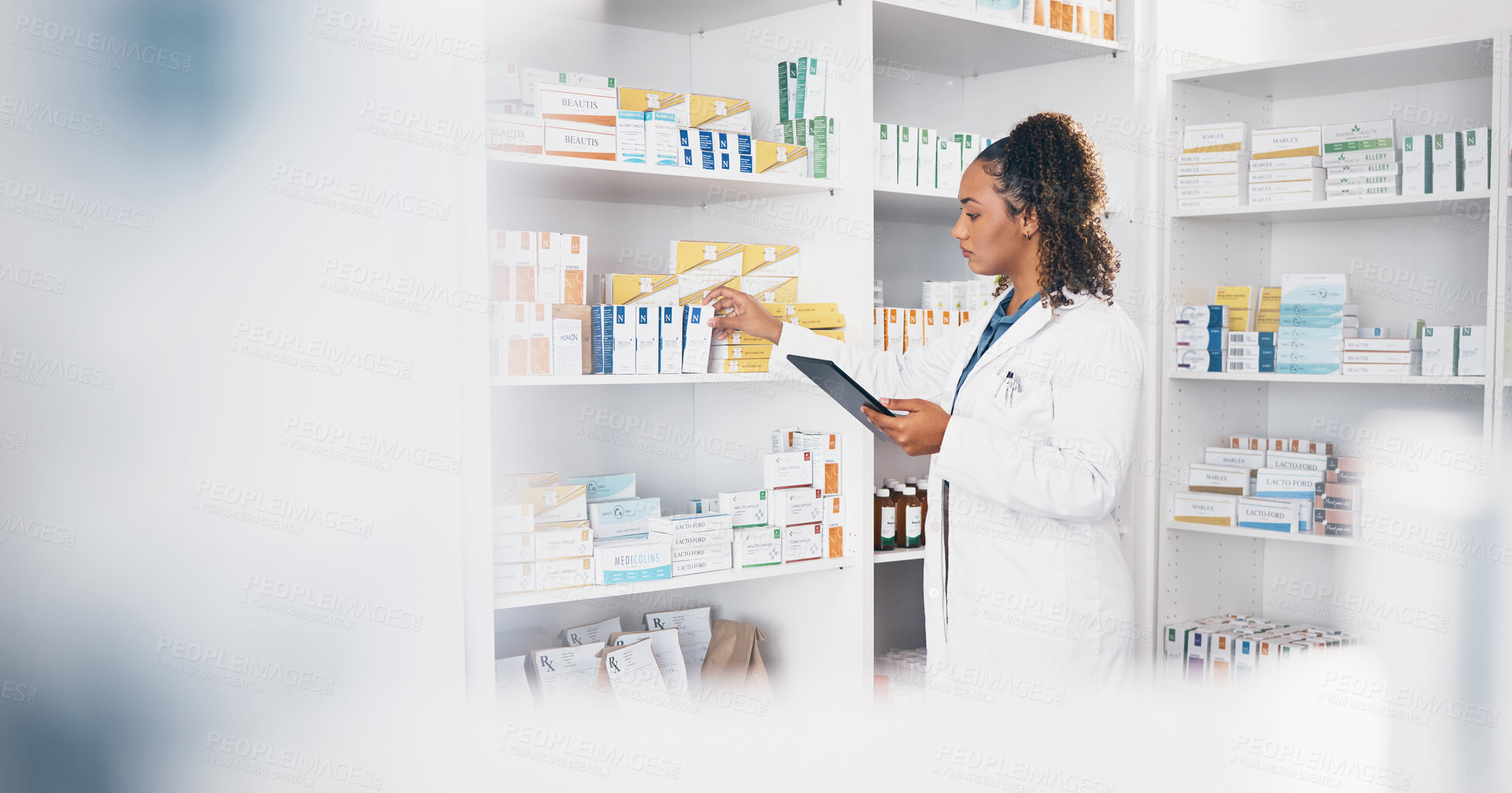 Buy stock photo Tablet, stock and medical with a woman in a pharmacy to fill an online order of prescription treatment. Healthcare, product and insurance with a female pharmacist working as a medicine professional