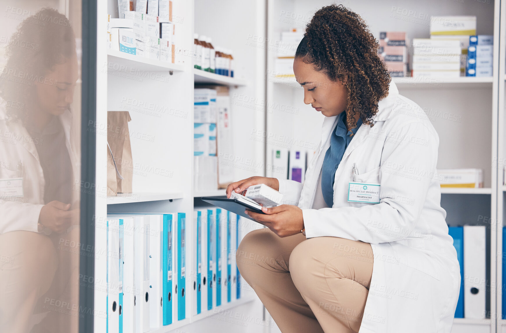 Buy stock photo Tablet, stock and product with a woman in a pharmacy to fill an online order of prescription treatment. Medical, healthcare and insurance with a female pharmacist working as a medicine professional