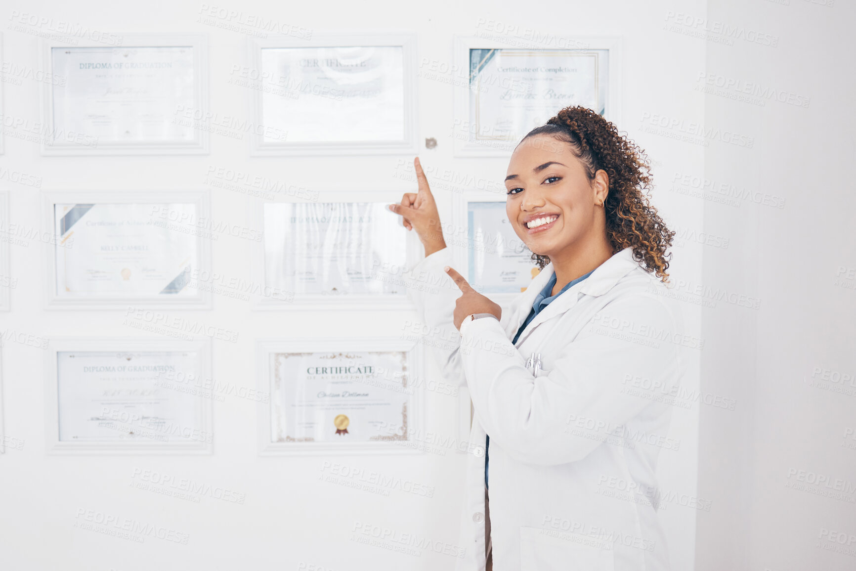 Buy stock photo Certificate, medical and pointing with portrait of woman for success, graduation and pride. Achievement, happy and smile with female and showing award wall for education, healthcare and pharmacy 