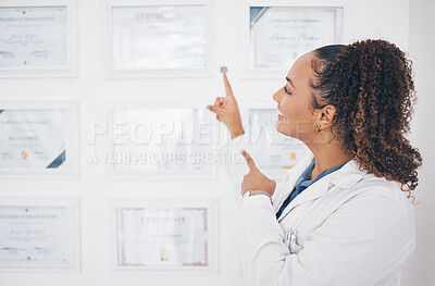 Buy stock photo Graduation, pointing and healthcare award with a woman proud of her medical achievement in the hospital. Face, smile and happy with a female medicine professional showing her certificate in a clinic