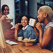 Business team, food and office at night while eating and drinking coffee  together at a desk. Diversity women group talking and laughing on late  break with takeout and collaboration at workplace |