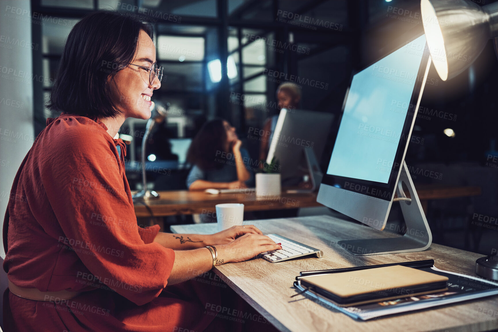 Buy stock photo Night, business and woman typing, smile and focus on data analysis, email and project deadline. Female employee, creative and worker with a computer, screen and working late for digital planning