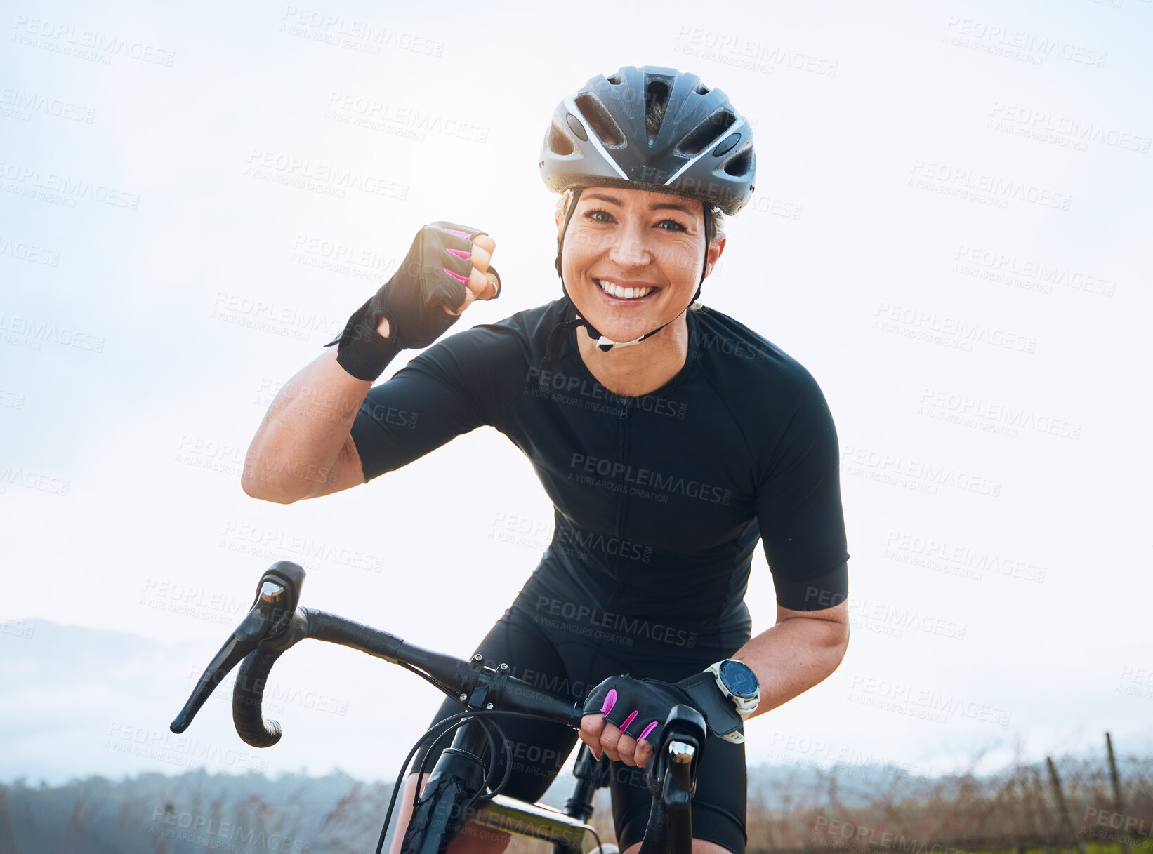 Buy stock photo Fitness, celebration and portrait of woman cycling with power fist, success or victory in the countryside. Happy, sports and face of lady cyclist celebrating workout achievement, milestone or winning