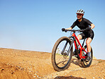 Bicycle, ride outdoor and woman on a bike with cycling for sports race on a gravel road. Fitness, exercise and athlete doing sport training in nature on trail for cardio and workout with mockup