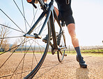 Closeup, bicycle wheel and cycling in nature on countryside street for rest, wellness or fitness. Cyclist woman, bike and sustainable travel in summer for adventure, health and tired on road workout