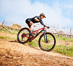 Bicycle, hill ride and woman outdoor on a bike with speed for sports race on a gravel road. Fitness, exercise and fast athlete doing sport training in nature on a park trail for cardio and workout