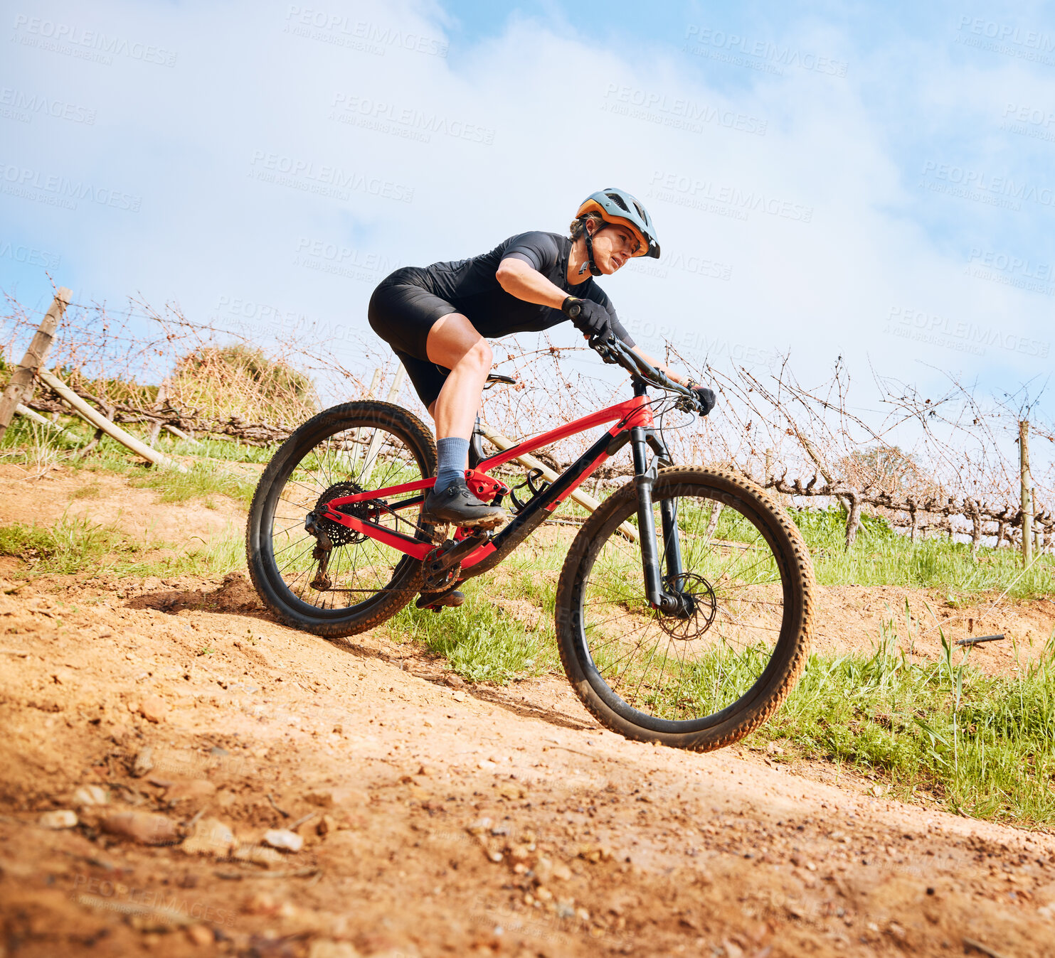 Buy stock photo Bicycle, hill ride and woman outdoor on a bike with speed for sports race on a gravel road. Fitness, exercise and fast athlete doing sport training in nature on a park trail for cardio and workout