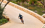 Bike, cycling and a sports person on a path outdoor for cardio or endurance exercise and health. Bicycle, fitness and workout with an athlete or cyclist training alone outside in the countryside