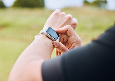 Buy stock photo Hands, training and smart watch with a sports person outdoor, checking the time during a workout. Arm, exercise and technology with an athlete tracking cardio or endurance performance for fitness