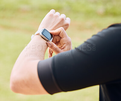 Buy stock photo Hands, fitness and smart watch with a sports person outdoor, checking the time during a workout. Arm, exercise and technology with an athlete tracking cardio or endurance performance while training