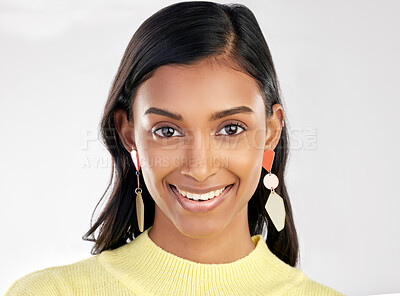 Buy stock photo Portrait, fashion and beauty with a woman on a white background in studio wearing earrings or accessories. Face, smile and happy with an attractive young indian female closeup for contemporary style