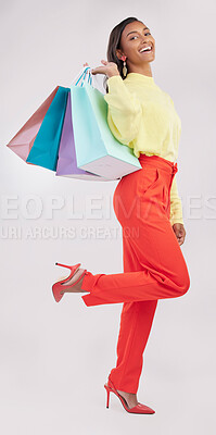 Buy stock photo Portrait, retail and sale with a woman customer in studio on a gray background for shopping or consumerism.  Fashion, luxury or happy with a female consumer or shopper carrying bags on her shoulder