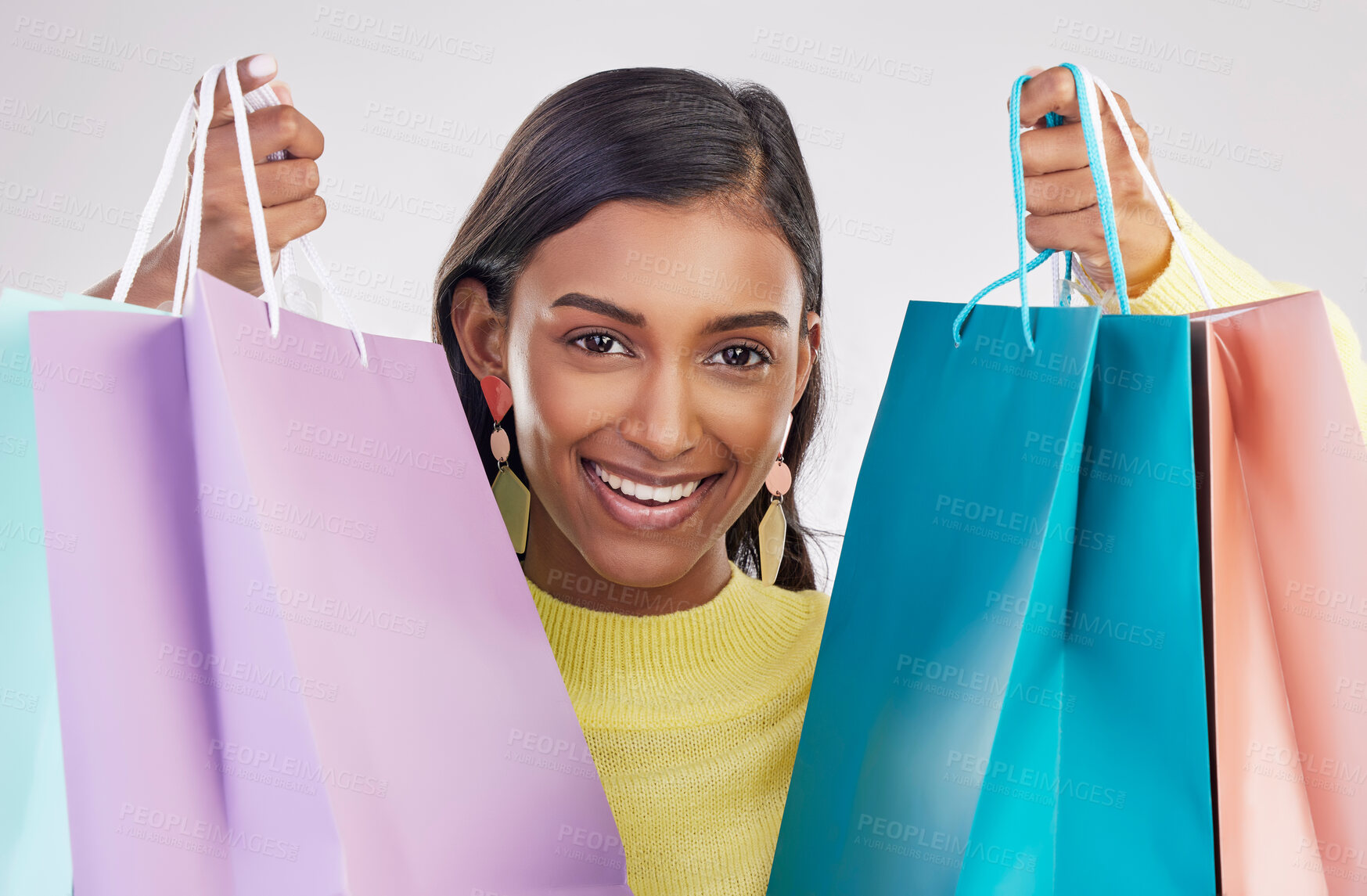 Buy stock photo Portrait, shopping and smile with a woman customer in studio on a gray background for retail or consumerism.  Fashion, luxury and happy with a female consumer or shopper showing bags of bargains