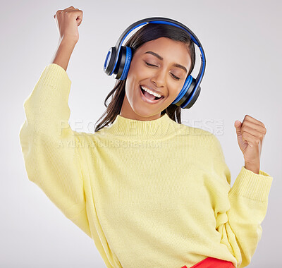 Buy stock photo Woman with headphones, listen to music and happy on studio background with freedom, fun and peace. Smile, carefree and technology with entertainment, Indian female and radio streaming  playlist