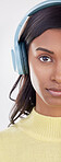 Serious, half and portrait of a woman with headphones for music isolated on a white background. Cropped, young and an Indian girl listening to audio, streaming radio or podcast on a backdrop