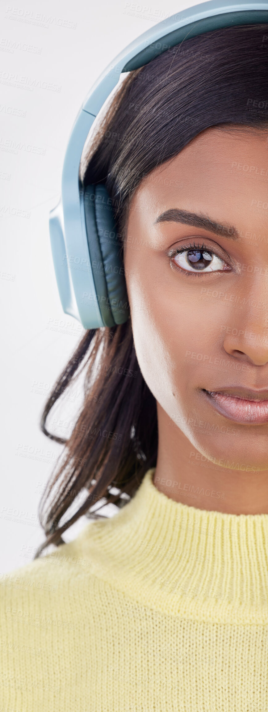 Buy stock photo Serious, half and portrait of a woman with headphones for music isolated on a white background. Cropped, young and an Indian girl listening to audio, streaming radio or podcast on a backdrop