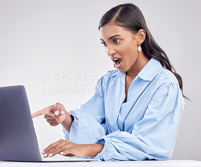 Buy stock photo Shock, laptop and a pointing business woman in shock on a white background in studio while working. Wow, computer and hand gesture with a surprised female employee looking at an online notification