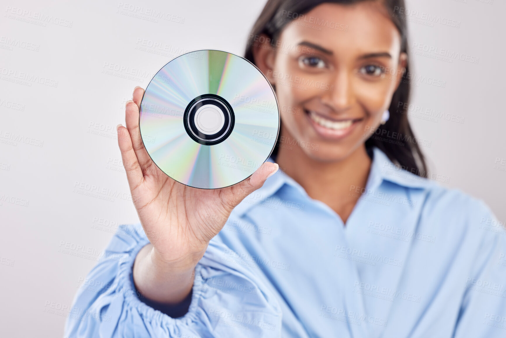 Buy stock photo Woman, compact disk and smile in studio portrait for programming, software and information technology. Young indian girl, cd and happy with movie, music and data storage for media by white background