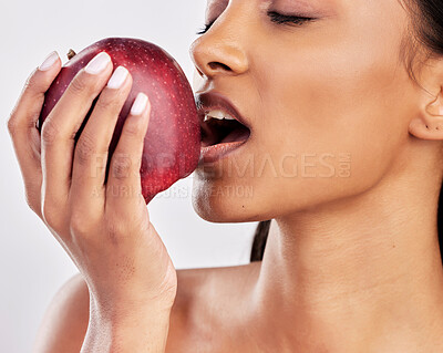 Buy stock photo Bite, apple or healthy Indian woman with skincare beauty or wellness in studio on white background. Food nutrition, eyes closed or face of girl model eating red fruits to promote vitamin c or diet