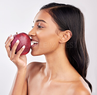 Buy stock photo Woman, apple with face profile and health with nutrition and fruit, healthy food and diet on studio background. Weight loss, organic and fresh produce with happy female eating, wellness and lifestyle