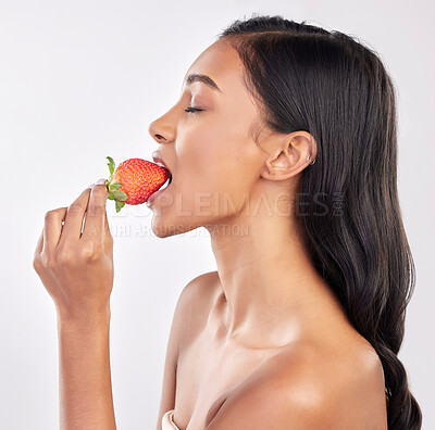 Buy stock photo Woman, skincare and studio profile with strawberry, eating and wellness with beauty, natural glow and health. Model, diet and nutrition with fruit, cosmetics and healthy lifestyle by white background