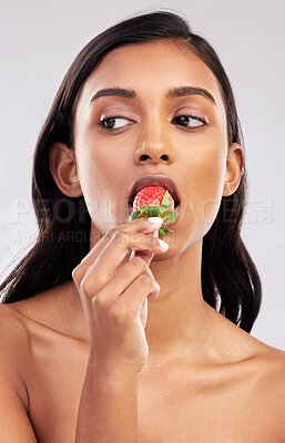 Buy stock photo Eating strawberry, studio or healthy Indian woman with skincare beauty or wellness in headshot. Food nutrition, bite or face of girl model with vitamin c or red fruits isolated on a white background