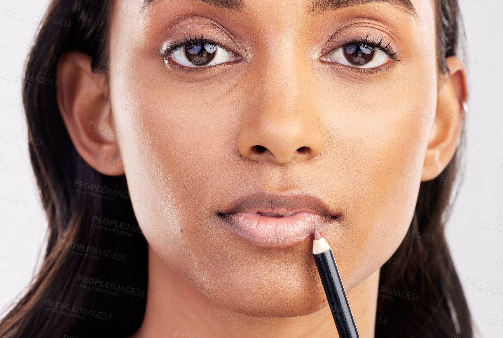 Buy stock photo Woman, face closeup and portrait with lip liner makeup, beauty and cosmetic product on studio background. Indian female, cosmetics pencil for lips and lipstick with healthy skin and cosmetology