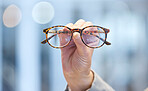 Optometry, vision and optometrist hand with glasses for eye care, optical wellness and healthcare. Medical, optic and closeup of woman with spectacles with stylish frame and prescription lens in shop