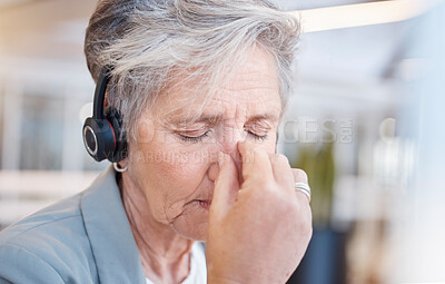 Buy stock photo Senior woman, headache and tired at call center with stress from consulting, telemarketing or crm job. Elderly female, tech support consultant and exhausted in office with burnout, fatigue or anxiety