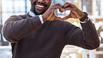 Hands, heart and black man showing love gesture, sign or symbol feeling happy, support excited in an office. Care, employee and businessman with loving or hearty shape, emoji and icon at work