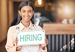 Woman, hiring sign and portrait smile in small business for recruitment, hire or job opportunity at cafe. Happy and confident female employer or owner with poster for recruiting or advertising