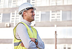 Construction worker, vision and motivation with a man architect standing arms crossed on a building site. Engineering, happy and smile with a male contractor working in the architecture industry