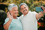 Senior couple, video call and phone in park, garden and contact on mobile voip communication. Retirement, old man and happy woman wave for selfie, smartphone and smile for hello, chat or online media