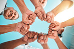 Fist, hands circle and below group of family, men and women for support, motivation or love. People, happy and hand together with solidarity, bonding or outdoor with sky, smile and vacation in summer