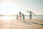 Beach, run and airplane by family playing, freedom and happy along the ocean on blue sky background. flying, game and children running with parents in Mexico for travel, trip and summer vacation