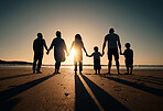 Family silhouette at beach, generations holding hands at sunset and people with love, care and support outdoor. Travel, adventure and freedom, grandparents and parents with kids back and ocean view