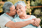 Senior couple, kiss and hug in park, garden and nature for love, care and happiness together. Happy man, woman and retirement of loving partner, relax and support in marriage, quality time or outdoor